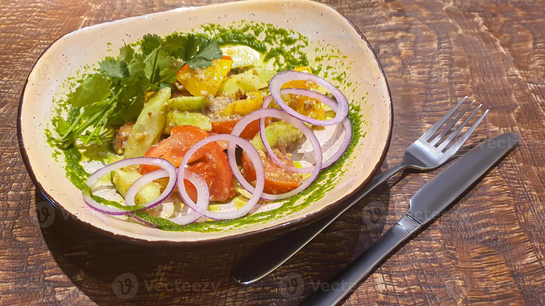 Diet salad of fresh vegetables. Lettuce, poached egg, tomatoes, green onions and chili peppers. Sauce. photo