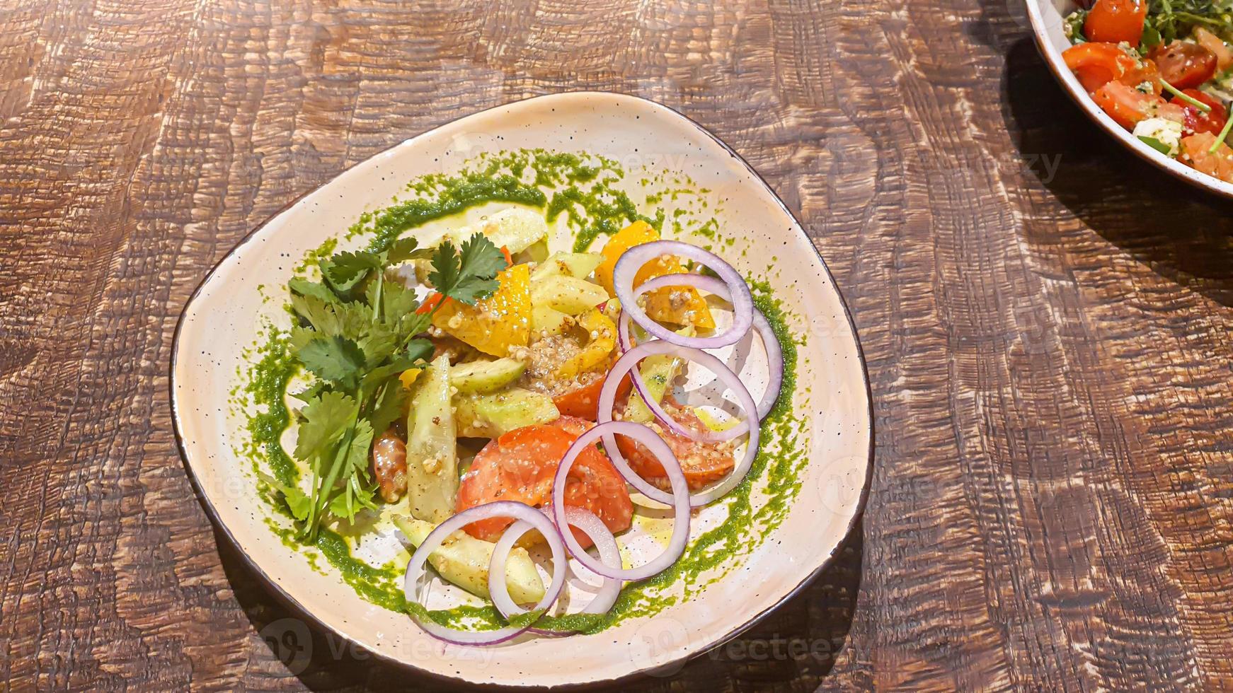 Diet salad of fresh vegetables. Lettuce, poached egg, tomatoes, green onions and chili peppers. Sauce. photo