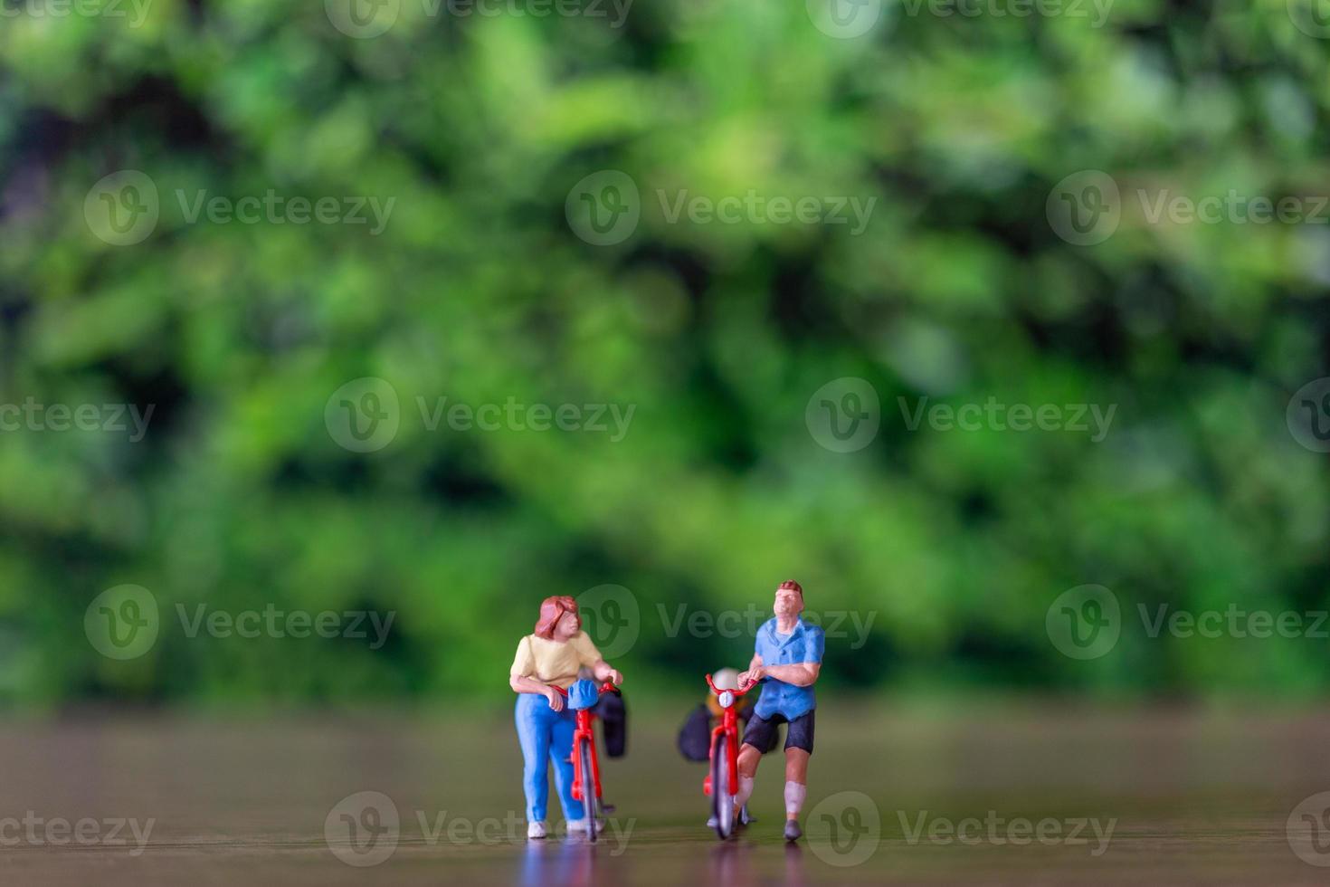 Miniature people standing with bike, World bicycle day concept photo