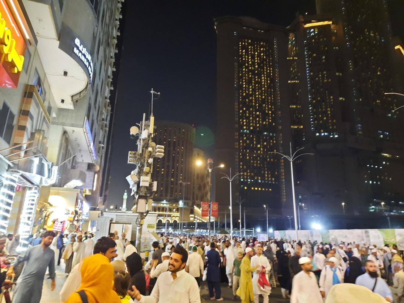 Mecca, Saudi Arabia, April 2023 - A beautiful view of pilgrims, tall buildings and lights at night on the outer road in Masjid al-Haram, Mecca. photo