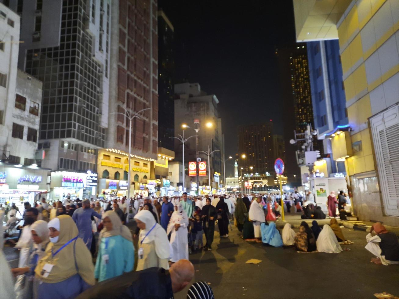 Mecca, Saudi Arabia, April 2023 - A large number of pilgrims from all over the world gather on the outer road near Masjid al-Haram, Mecca at night. photo