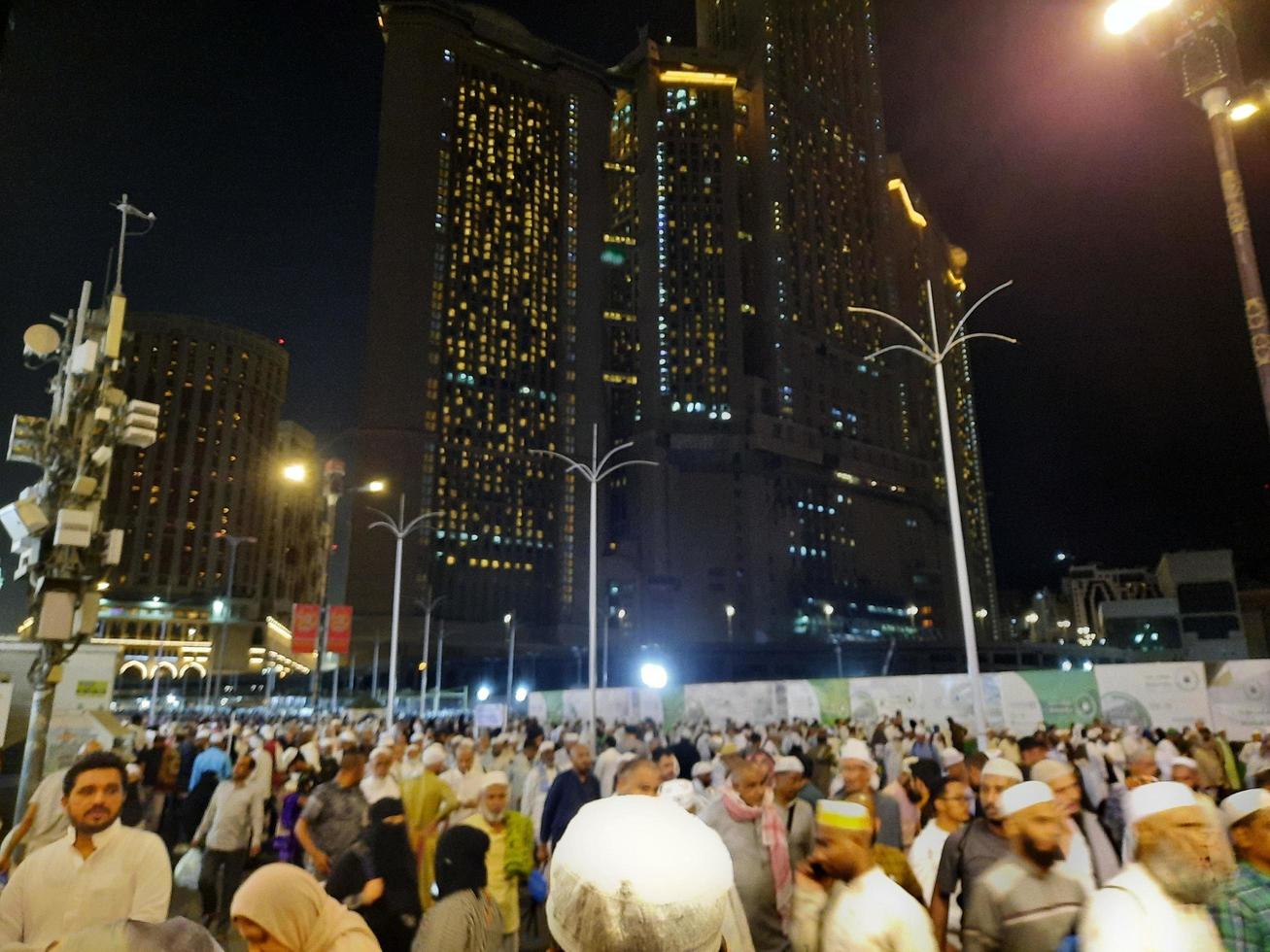 Mecca, Saudi Arabia, April 2023 - A large number of pilgrims from all over the world gather on the outer road near Masjid al-Haram, Mecca at night. photo
