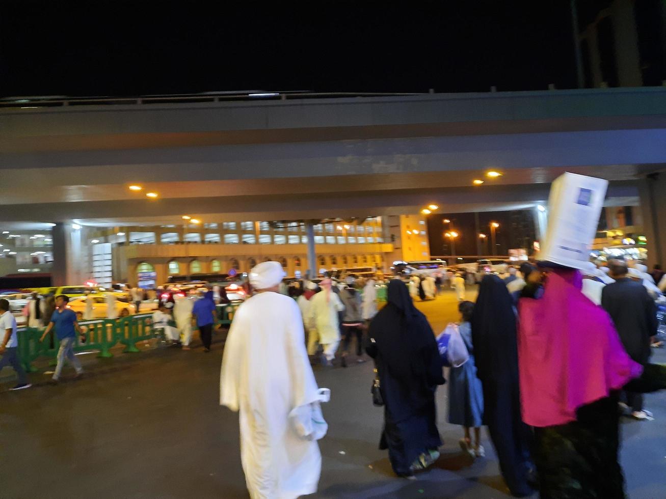 Mecca, Saudi Arabia, April 2023 - A large number of pilgrims from all over the world gather on the outer road near Masjid al-Haram, Mecca at night. photo