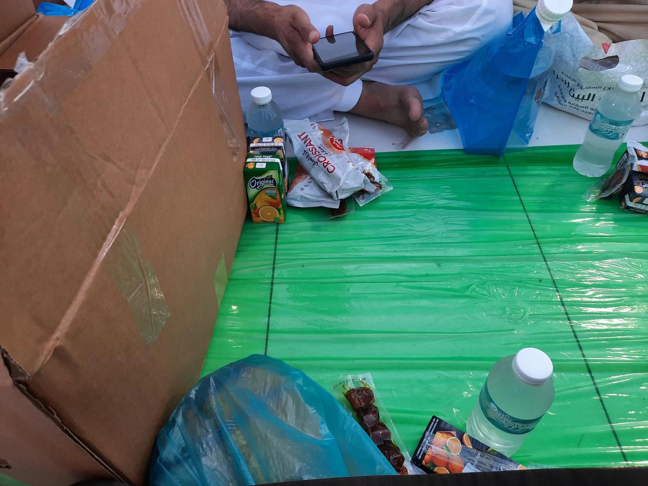 Mecca, Saudi Arabia, April 2023 - Pilgrims from different countries around the world are busy breaking their fast in the courtyard outside Masjid al-Haram. photo