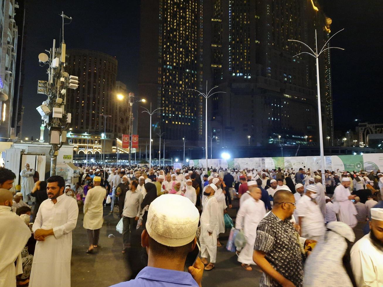 Mecca, Saudi Arabia, April 2023 - A large number of pilgrims from all over the world gather on the outer road near Masjid al-Haram, Mecca at night. photo