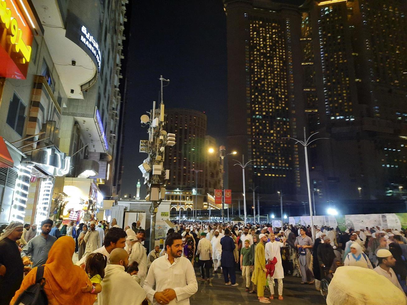 Mecca, Saudi Arabia, April 2023 - A large number of pilgrims from all over the world gather on the outer road near Masjid al-Haram, Mecca at night. photo