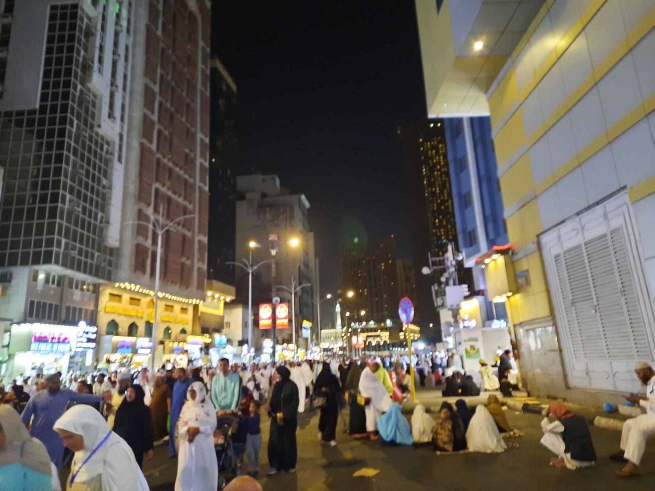 Mecca, Saudi Arabia, April 2023 - A large number of pilgrims from all over the world gather on the outer road near Masjid al-Haram, Mecca at night. photo