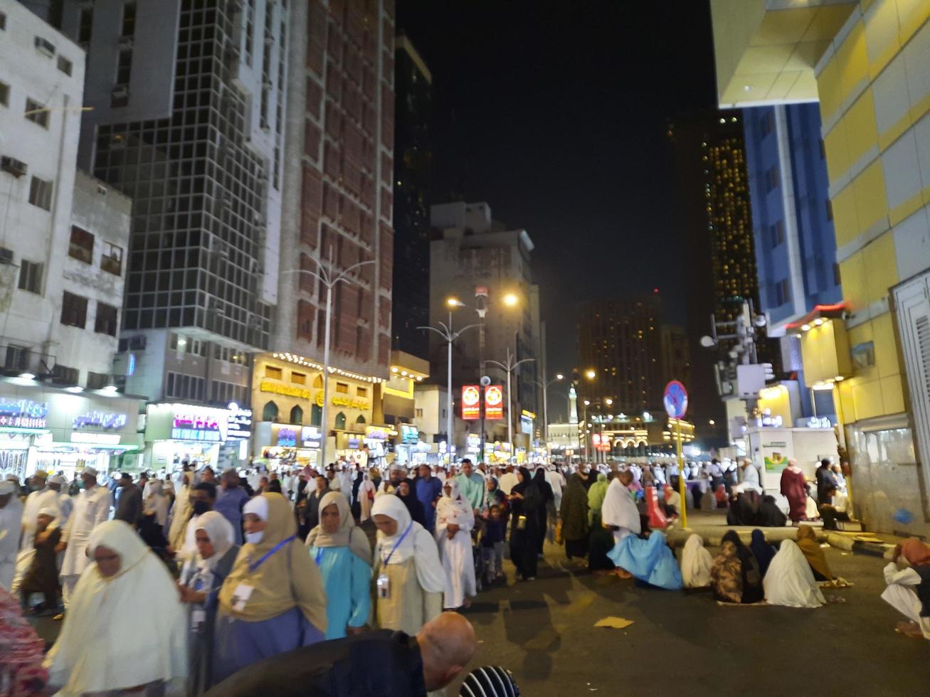 Mecca, Saudi Arabia, April 2023 - A large number of pilgrims from all over the world gather on the outer road near Masjid al-Haram, Mecca at night. photo