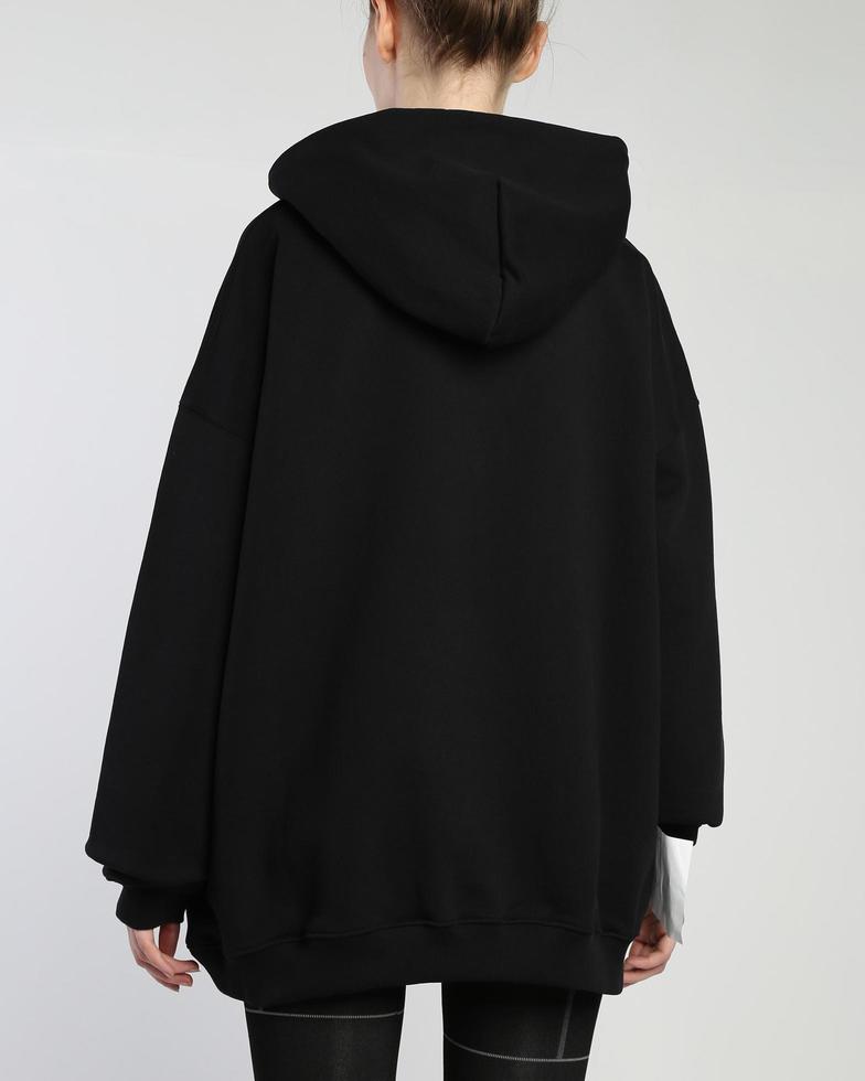 A woman wears a black hoodie photo