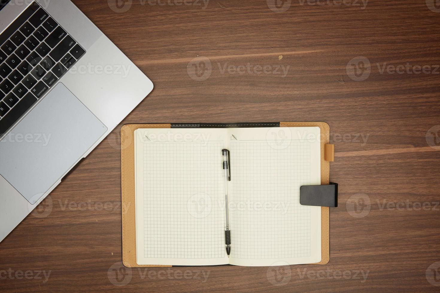 laptop, notepad on wooden table office concept, stationery, flat lay photo