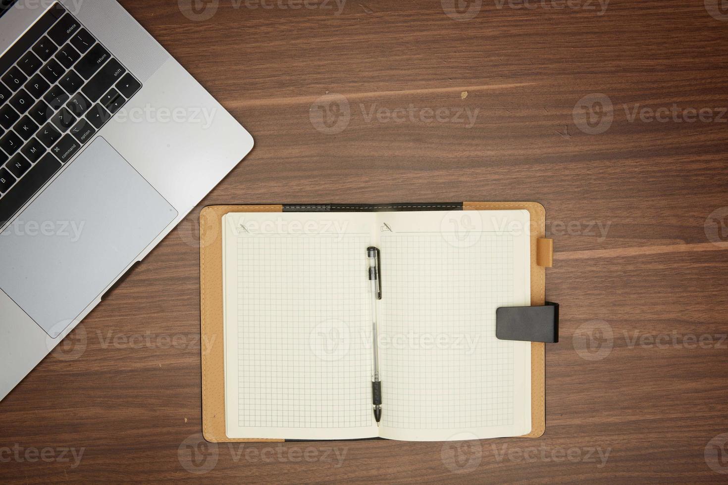 laptop, notepad on wooden table office concept, stationery, flat lay photo