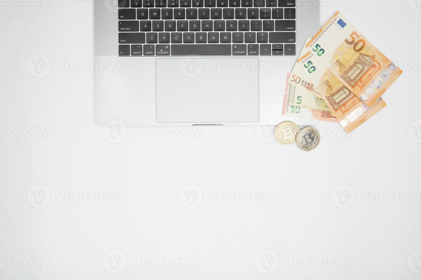 euro and bitcoin banknotes, cryptocurrency and blockchain concept on white background flat lay photo