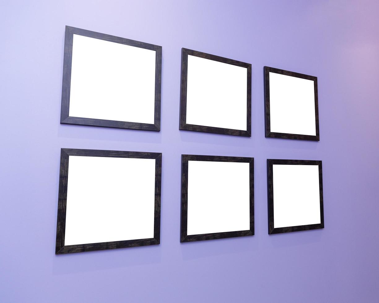 Four black frames on a purple wall with a white background. photo