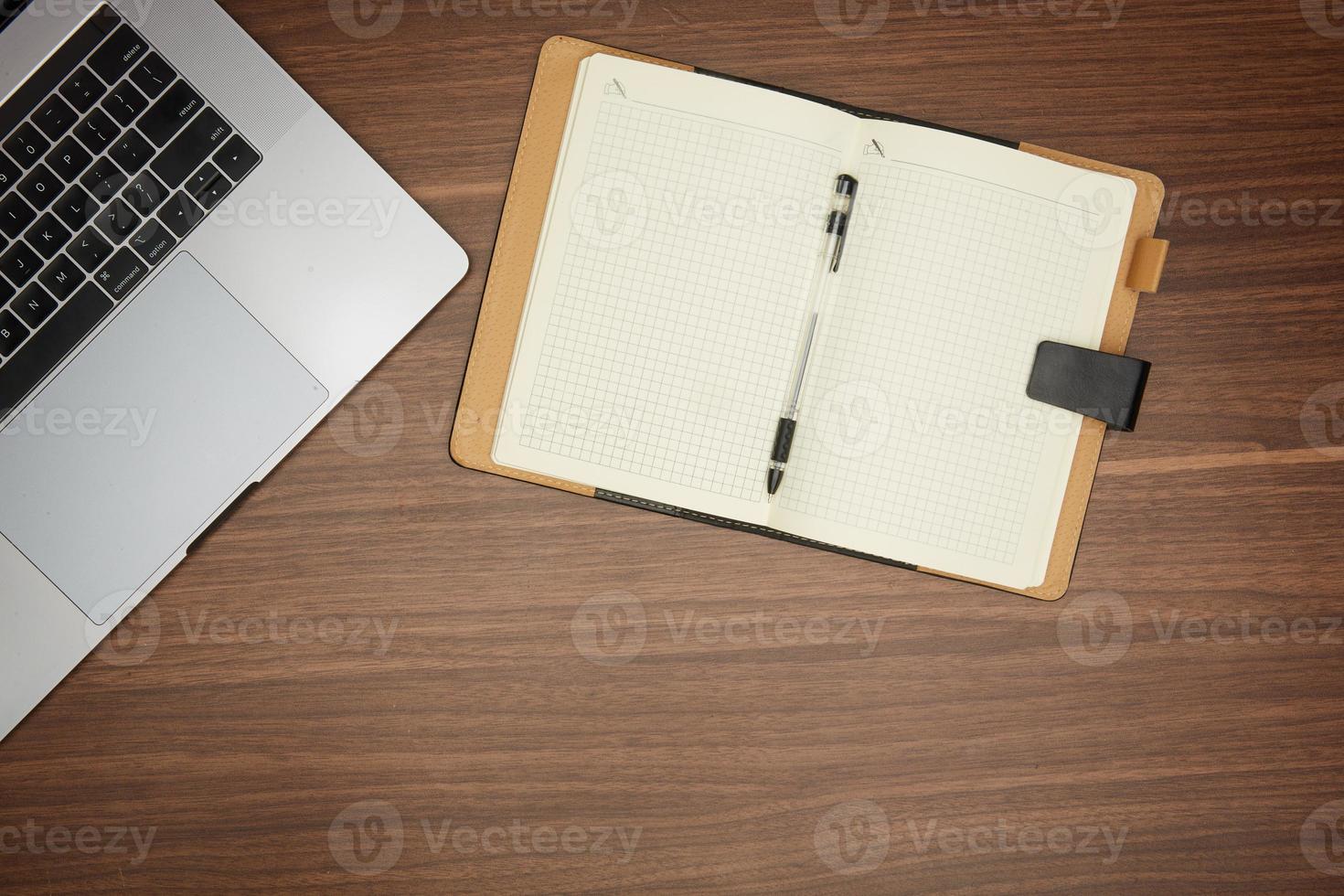laptop, notepad on wooden table office concept, stationery, flat lay photo