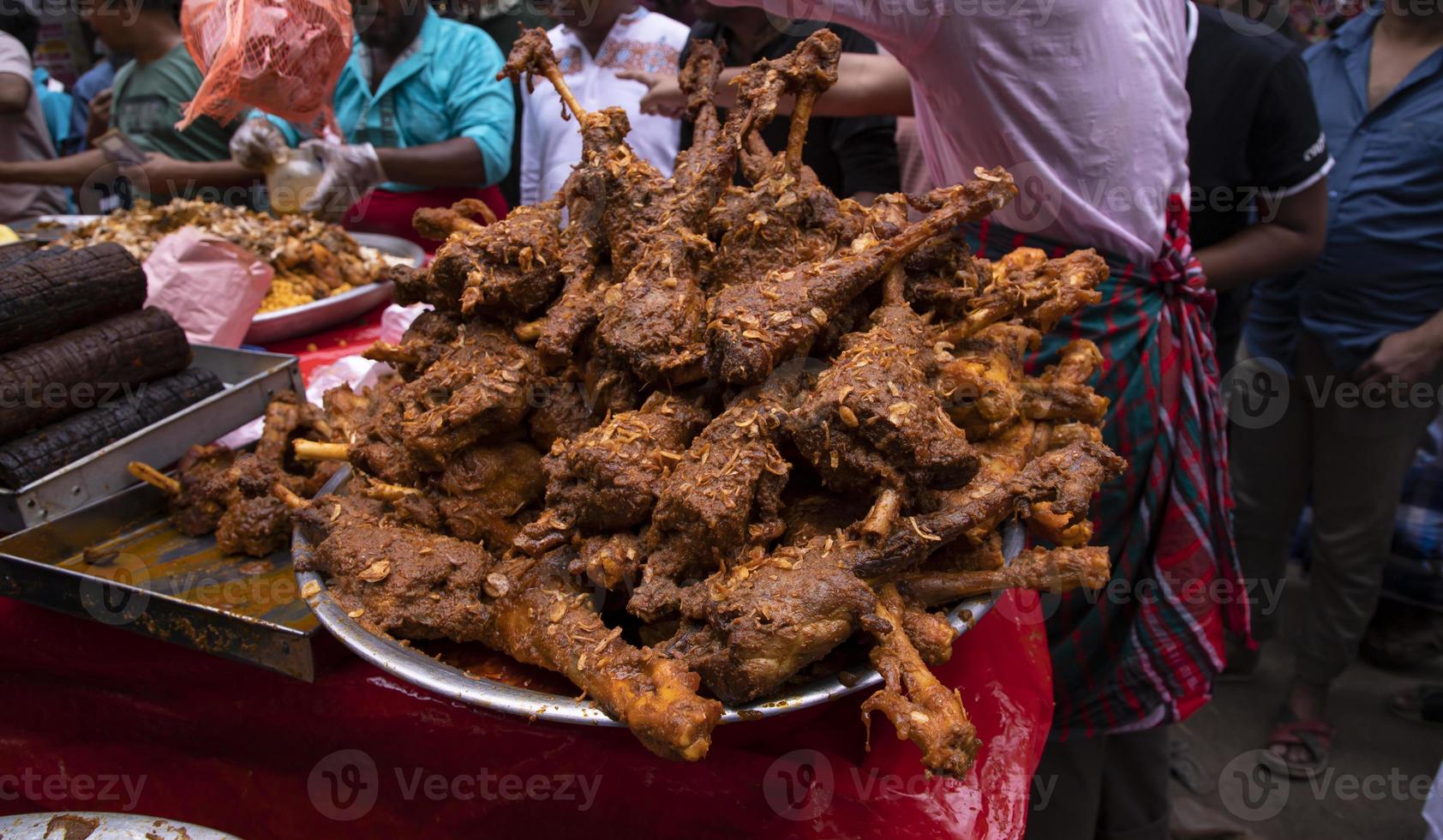 Roasted leg pieces of mutton at a street food market in Dhaka, Bangladesh photo