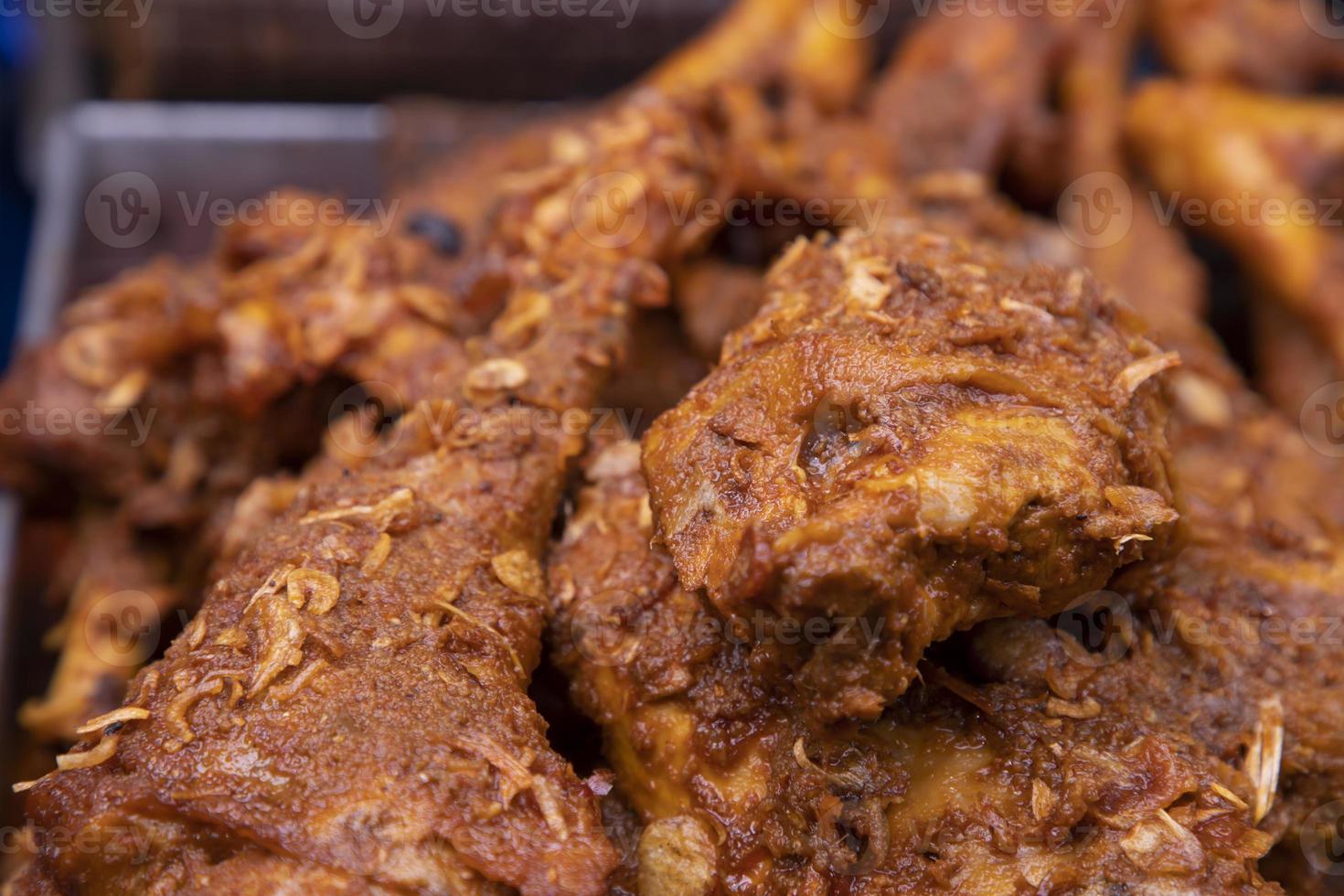 Roasted leg pieces of mutton at a street food market in Dhaka, Bangladesh photo