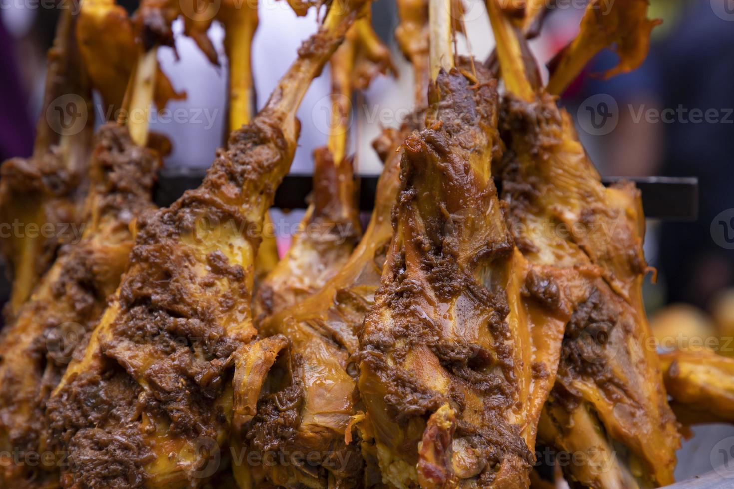 Roasted leg pieces of mutton at a street food market in Dhaka, Bangladesh photo