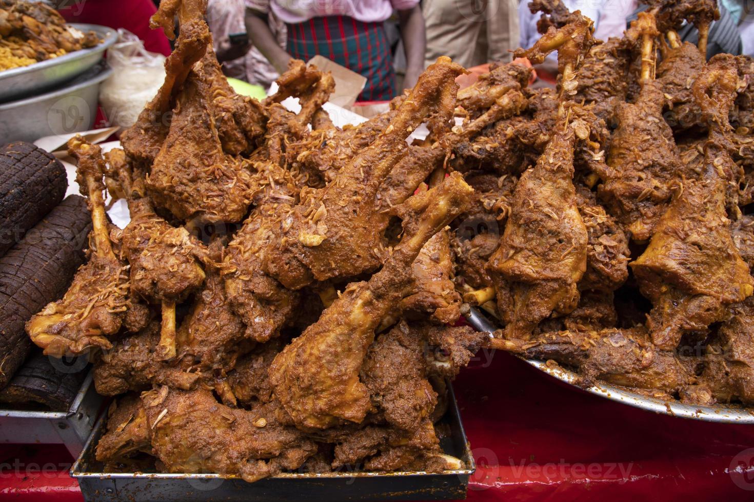 Roasted leg pieces of mutton at a street food market in Dhaka, Bangladesh photo