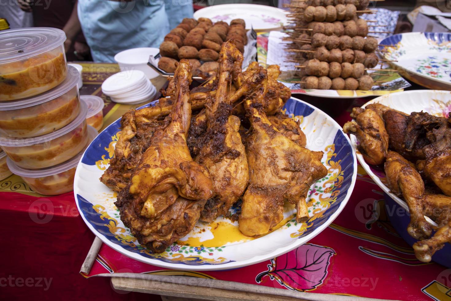 Roasted leg pieces of mutton at a street food market in Dhaka, Bangladesh photo