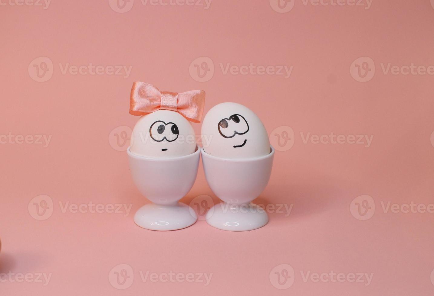 eggs with face and flowers on the pink bow, for Easter background photo