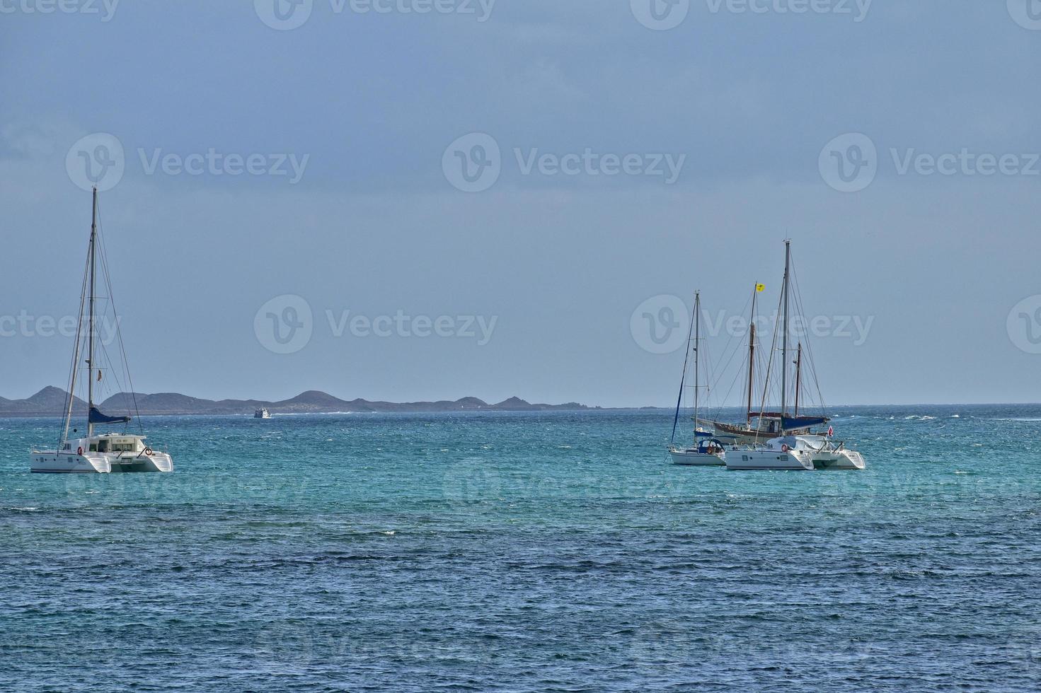 oceanic calm landscape on the Spanish island of Fuerteventura with boats photo