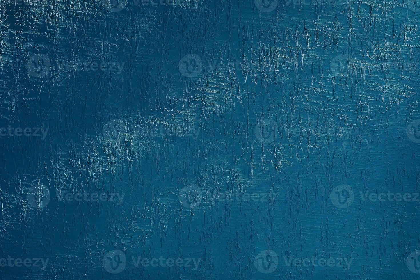 Bright blue wall with shadow from trees photo