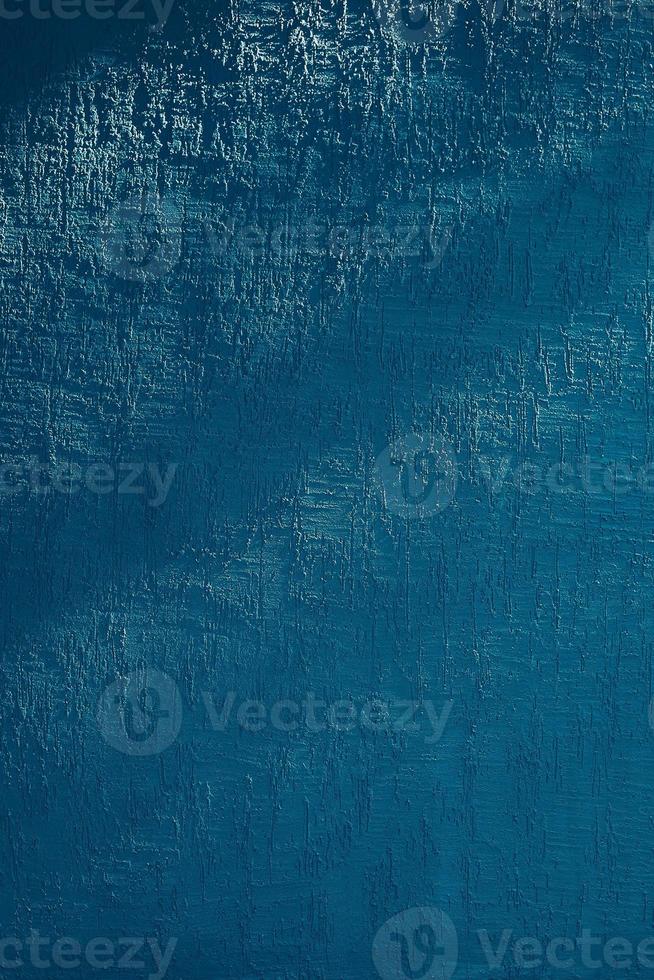 Bright blue wall with shadow from trees photo