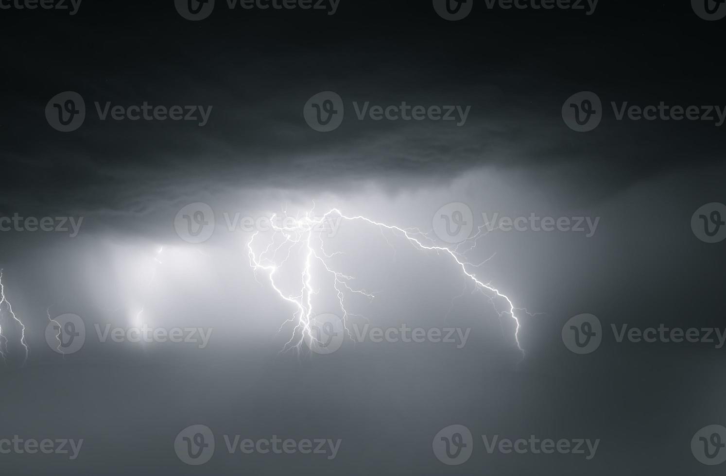 Lightning thunderstorm flash over the night sky. Concept on topic weather, cataclysms photo