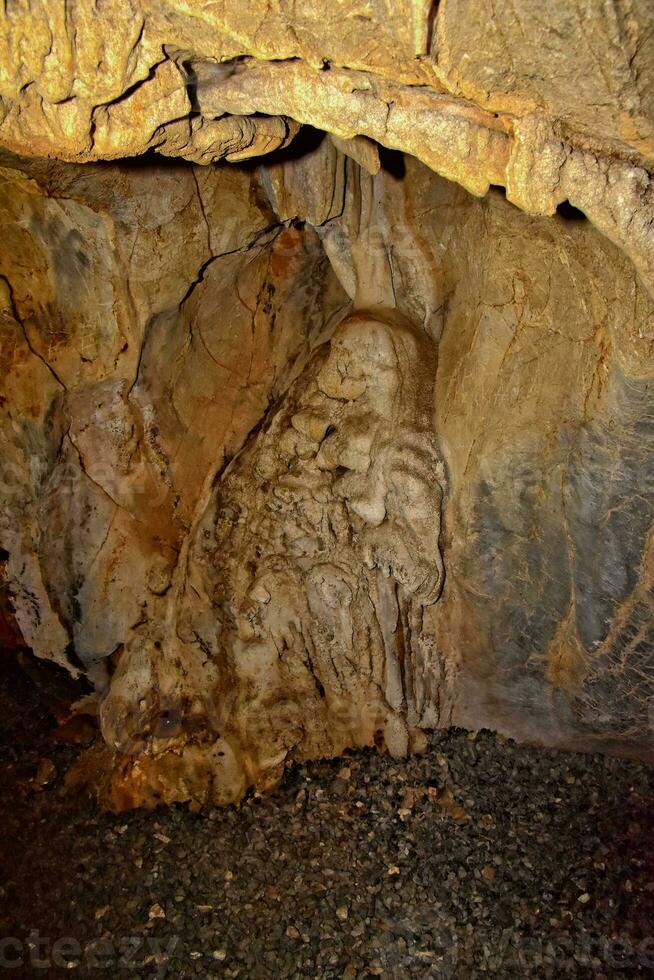 interesting original cave in the Turkish mountains with stalactites and stalagmites creating the background photo