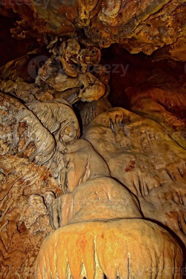 interesting original cave in the Turkish mountains with stalactites and stalagmites creating the background photo