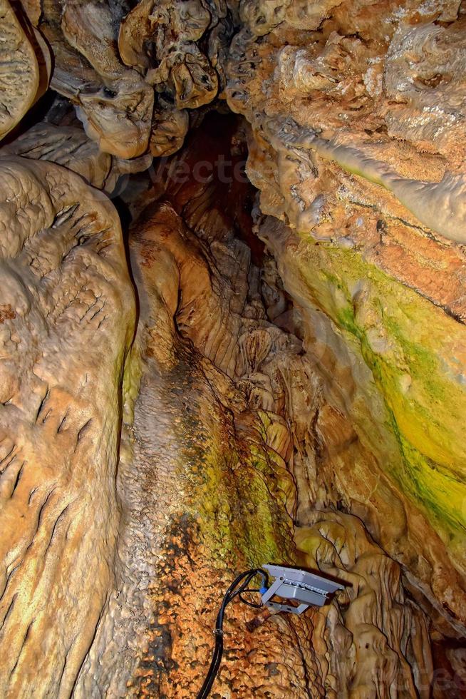 interesting original cave in the Turkish mountains with stalactites and stalagmites creating the background photo