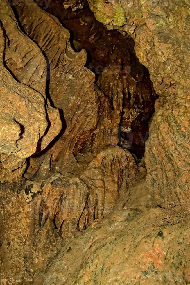 interesting original cave in the Turkish mountains with stalactites and stalagmites creating the background photo