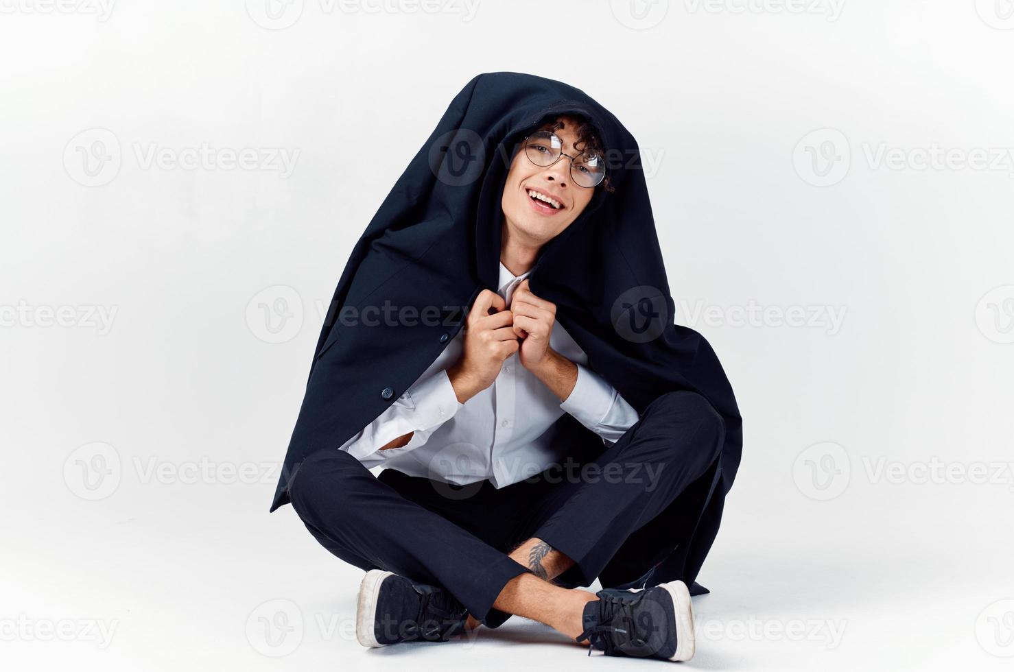 Cheerful guy in a classic suit with a jacket on his shoulders and gesturing with his hands Copy Space sneakers photo
