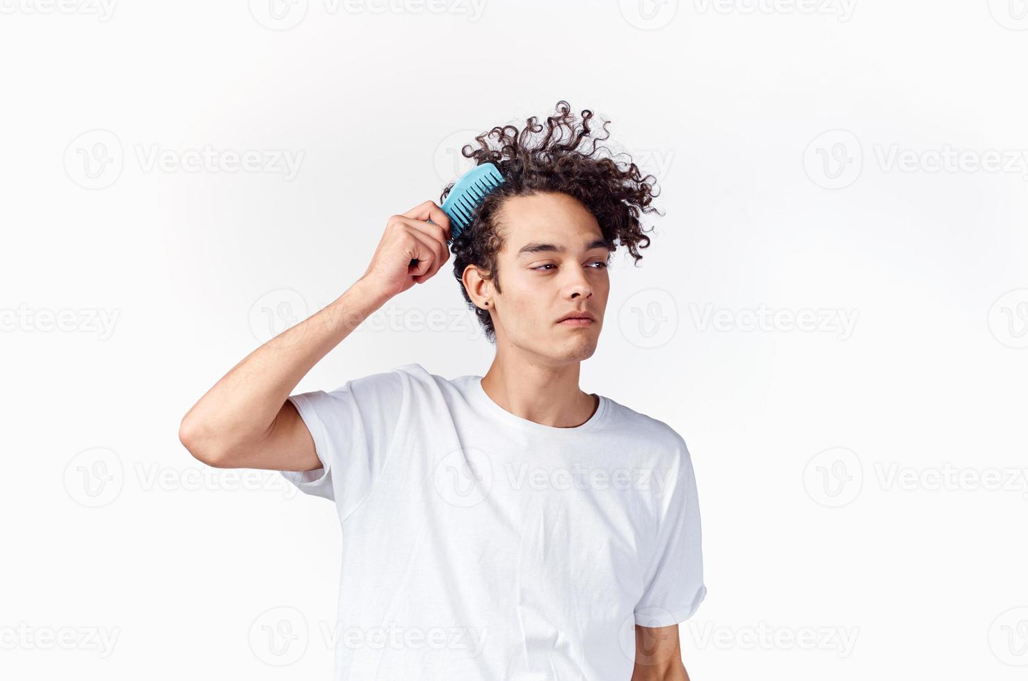 cheerful man in a white t-shirt comb hair curls emotions photo