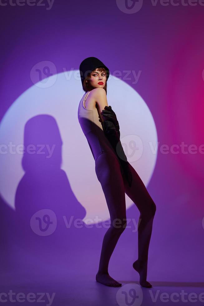 Beauty Fashion woman posing on stage spotlight silhouette disco purple background unaltered photo