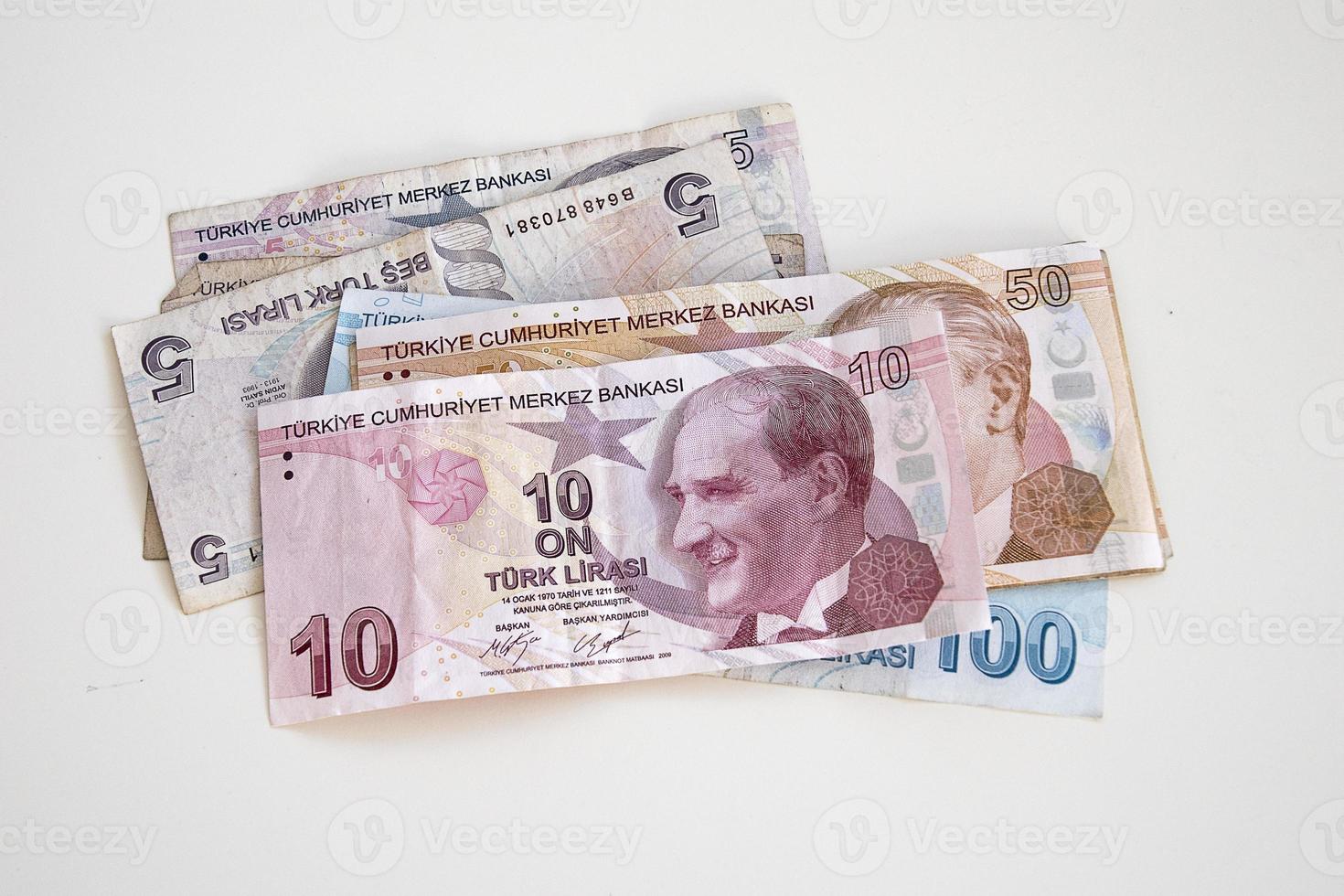 Turkish paper banknotes lying on a white table photo