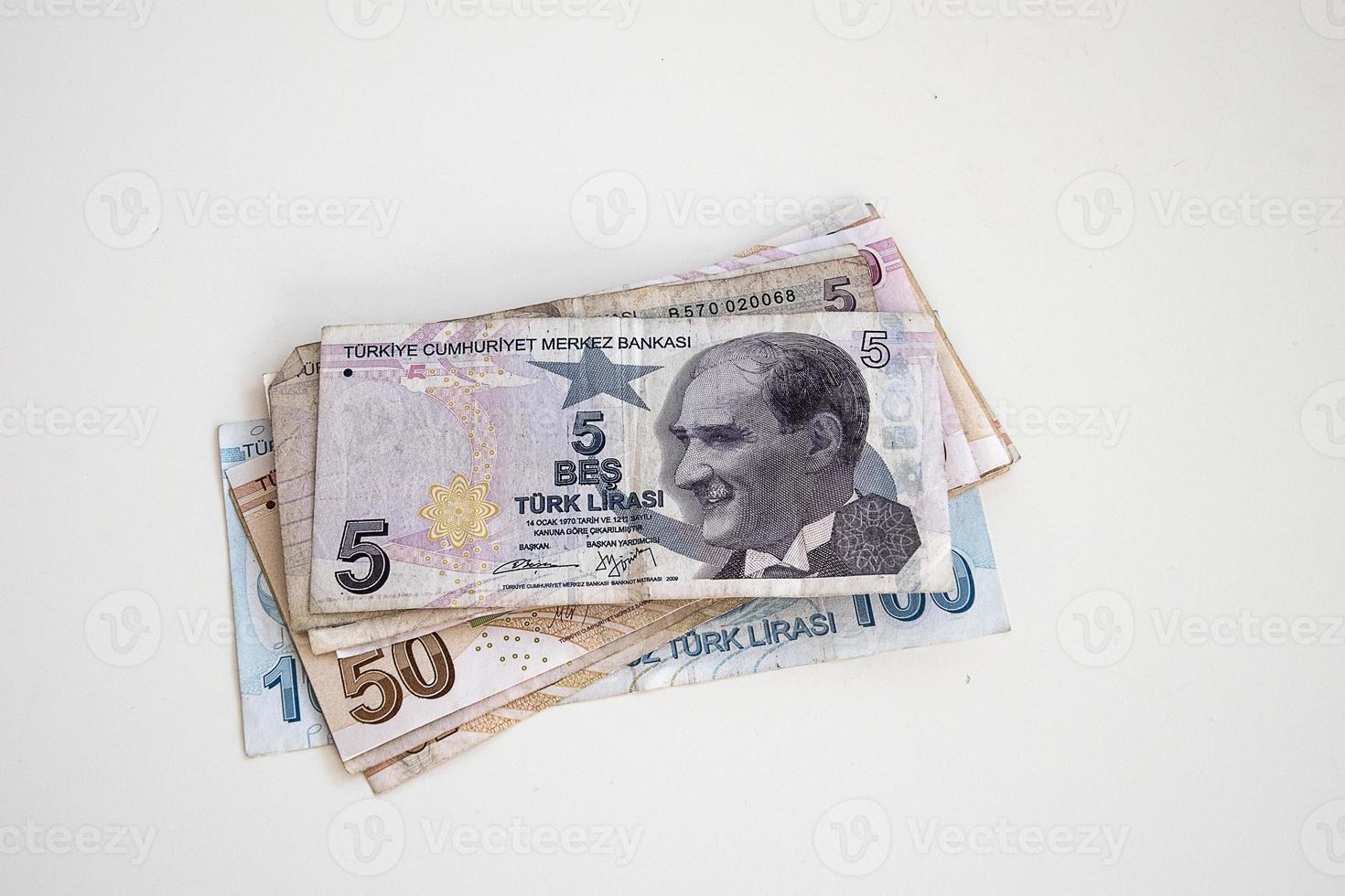 Turkish paper banknotes lying on a white table photo