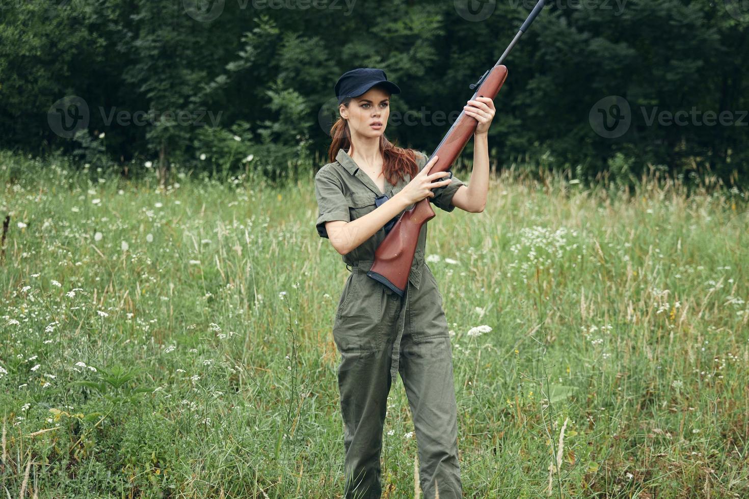 Woman on outdoor holding a gun in his hands fresh air travel hunting photo