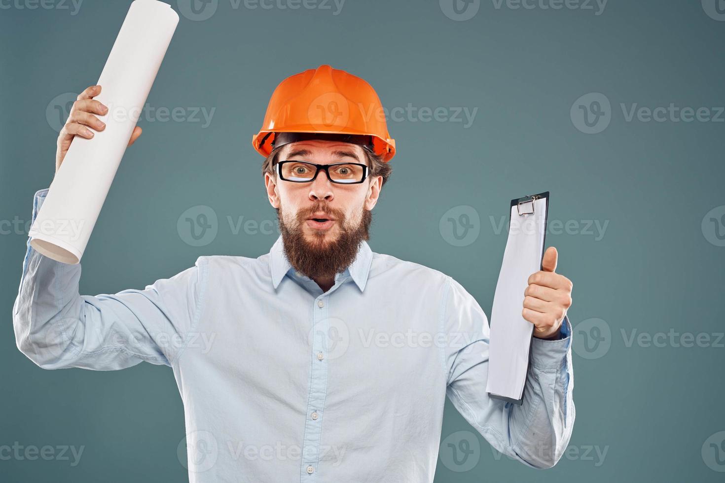Man in shirt with blueprints in hands construction professional emotions cropped view photo