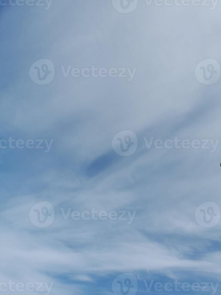 Beautiful white clouds on deep blue sky background. Large bright soft fluffy clouds are cover the entire blue sky. photo