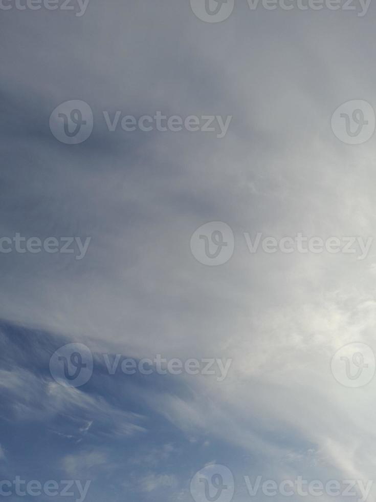 Beautiful white clouds on deep blue sky background. Large bright soft fluffy clouds are cover the entire blue sky. photo