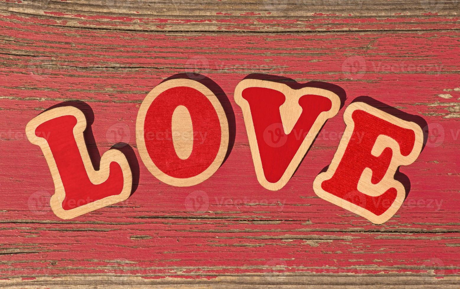 word love made of wooden letters on old red board photo