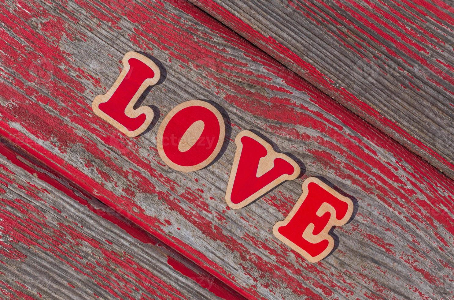 word love on plank of old wooden bench photo