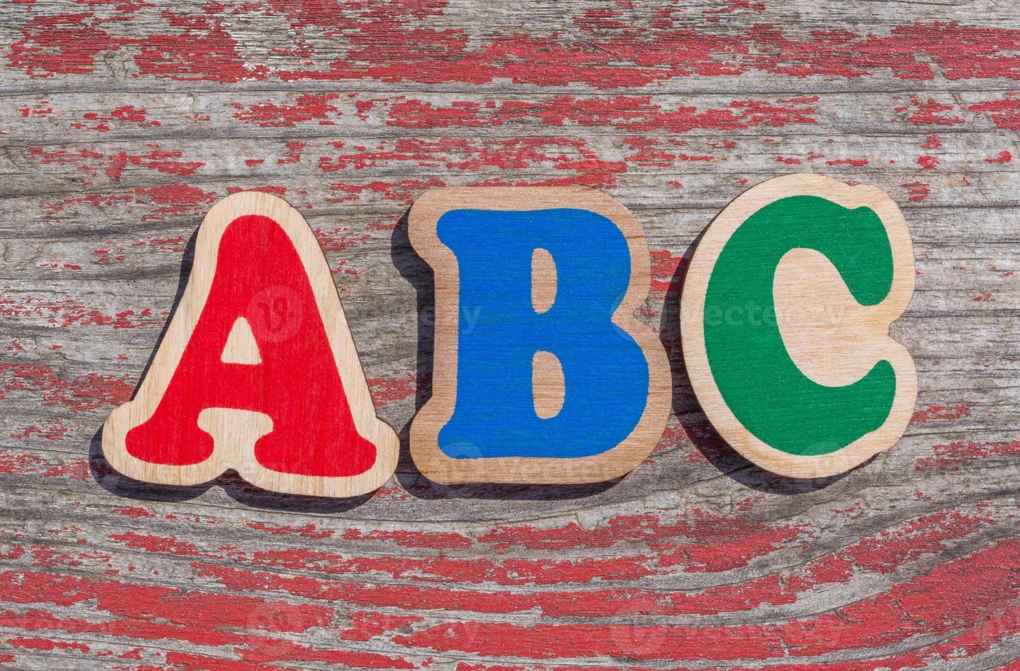 word ABC made of wooden letters on shabby wood background photo