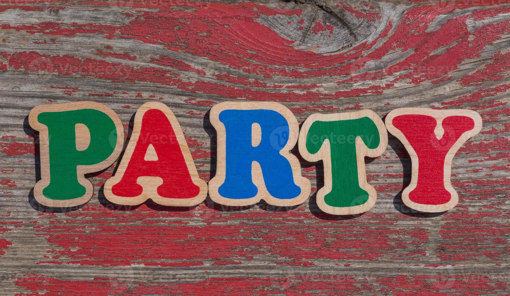 word party made of wooden letters on shabby wood background photo