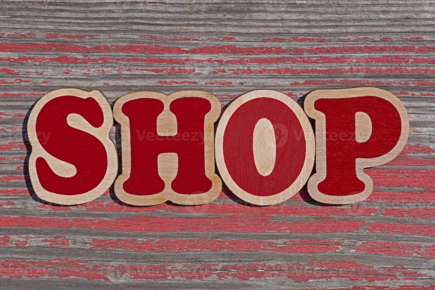 word shop made of wooden letters on aged wooden board photo