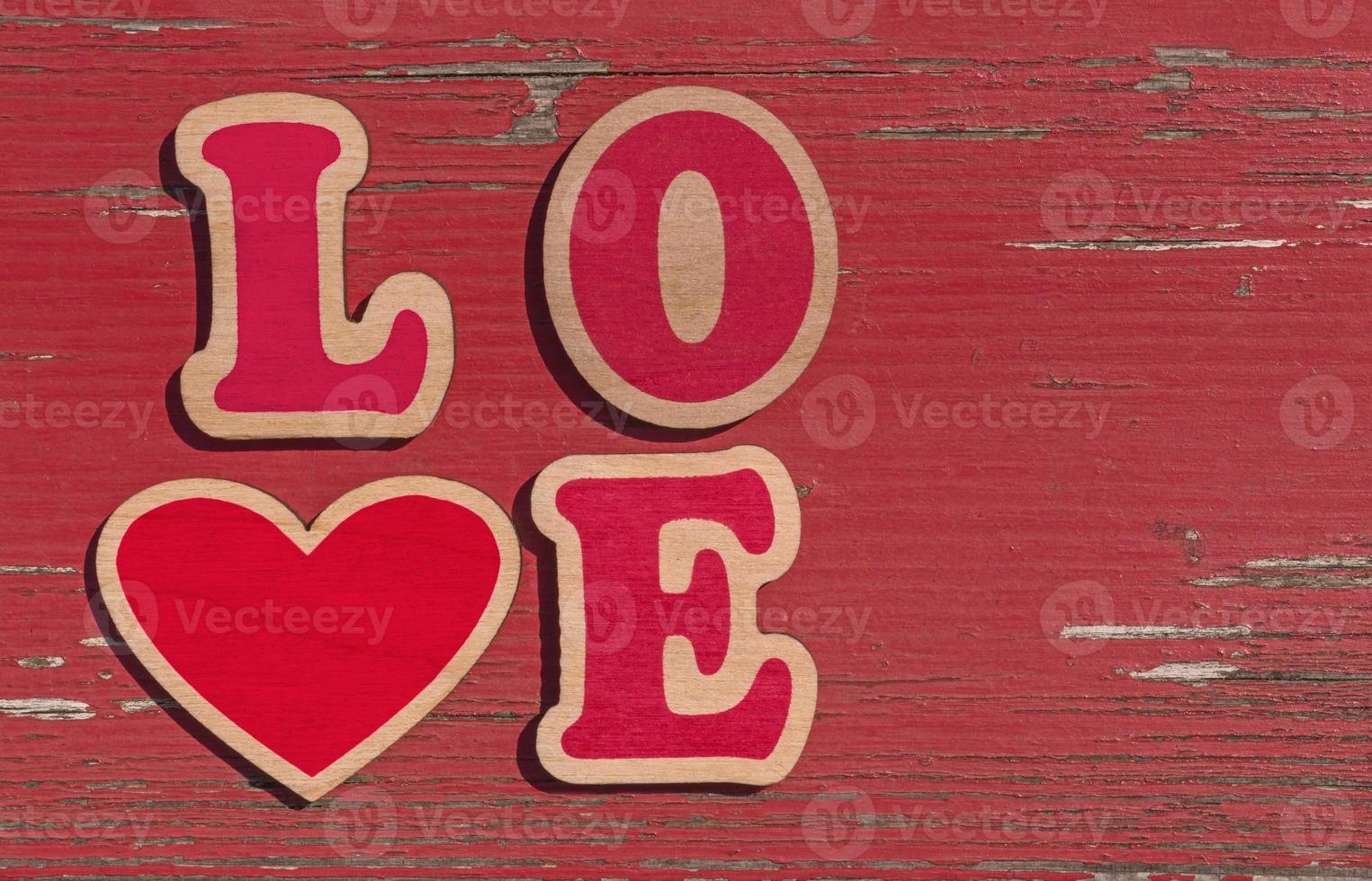 word love made of wooden letters on red shabby wooden background photo