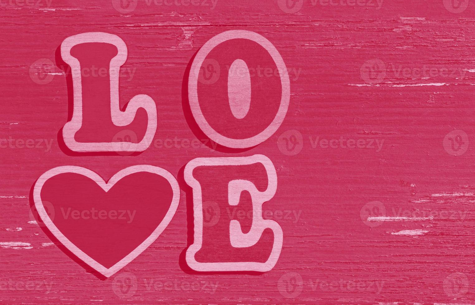 pink Valentines Day background, word love made of wooden letters photo
