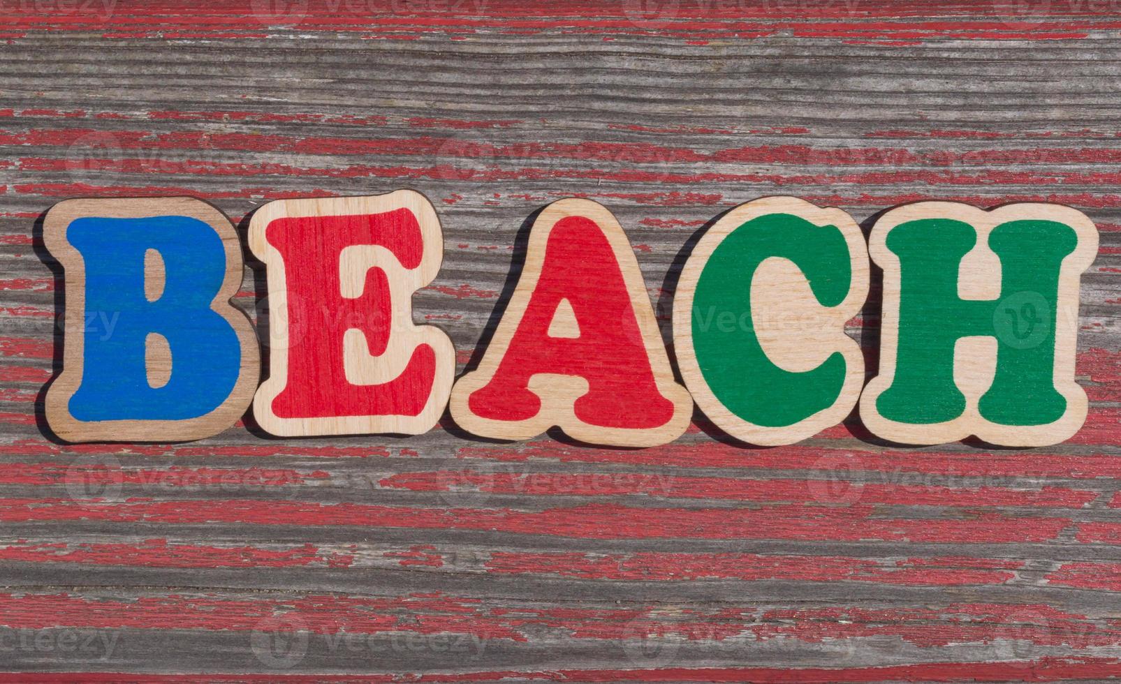 word beach made of wooden letters on shabby wood background photo