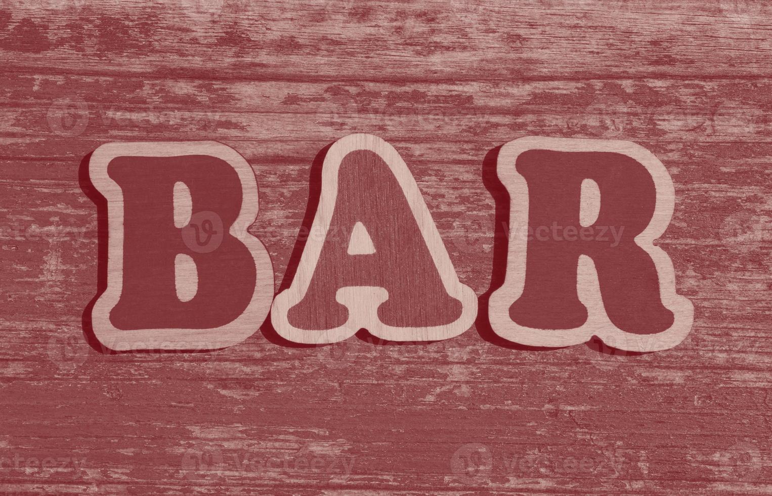 word bar made of wooden letters on wood background photo